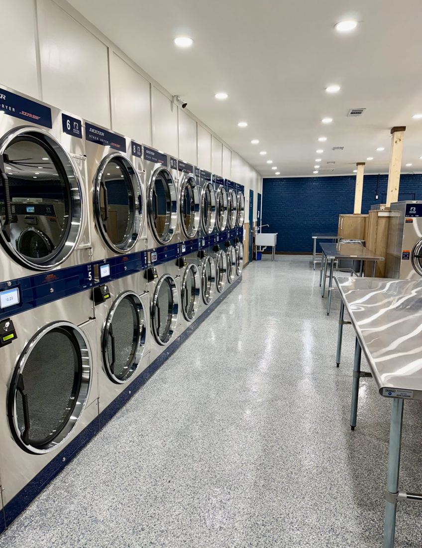 Long row of stack dryers and folding tables